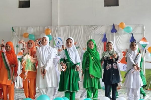 Children performing on a decorated stage at a DAPS Raebareli school programme