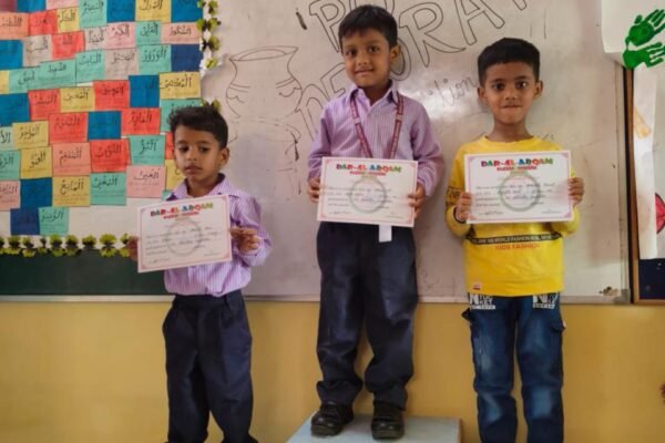 Students on the winners' podium holding their certificates at DAPS Raebareli