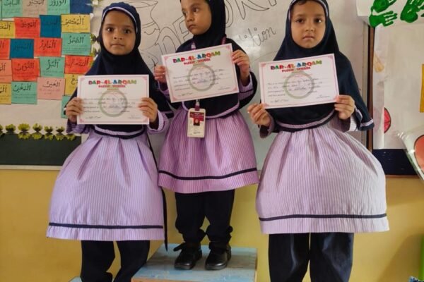 Students standing on the winners' podium with certificates in a DAPS Raebareli classroom